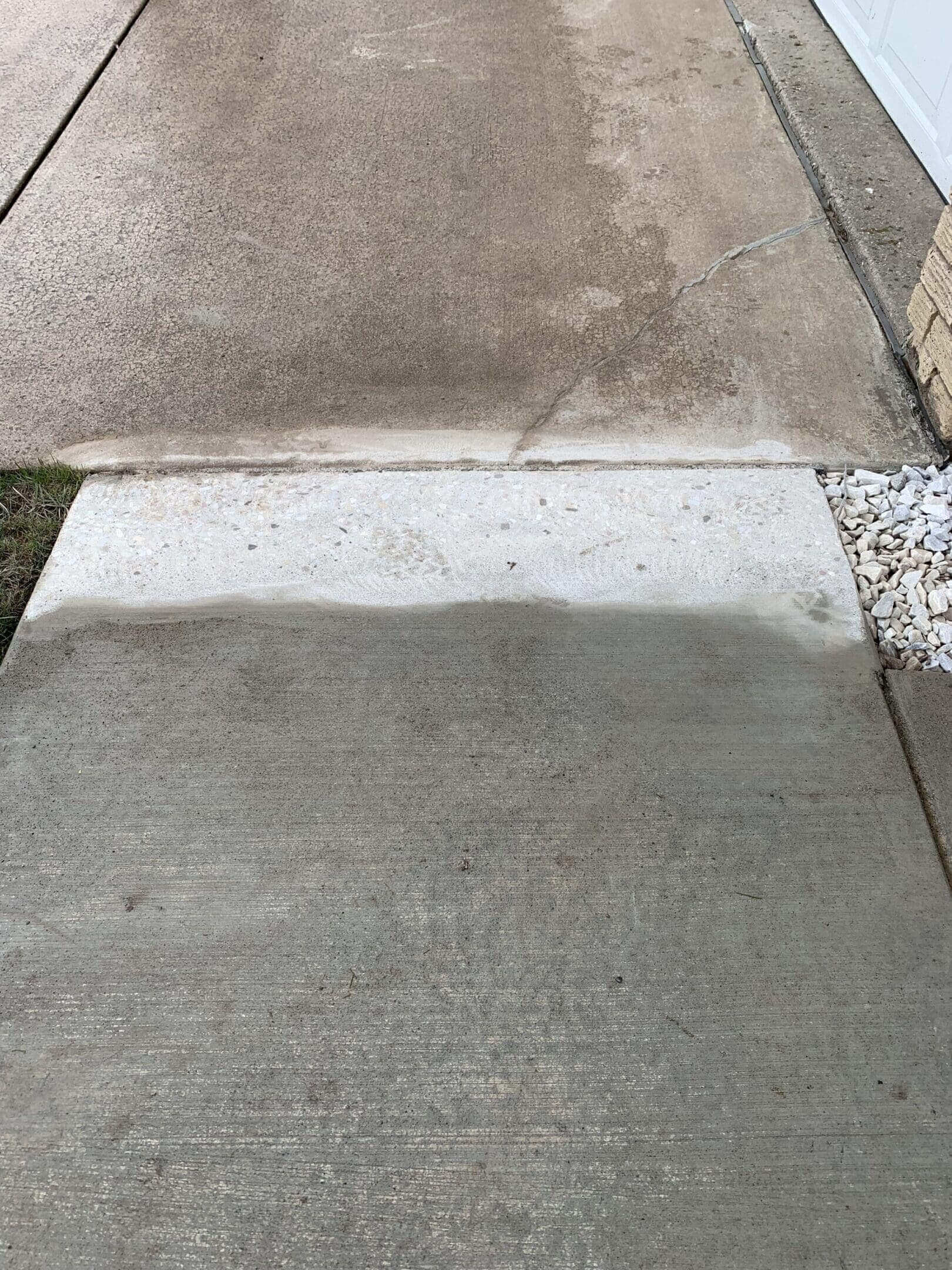 Concrete driveway showing visible cleaning and repair results