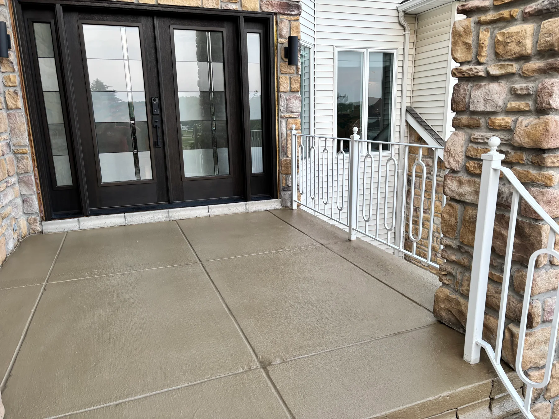 Finished front porch concrete overlay and entry landing near Buffalo NY